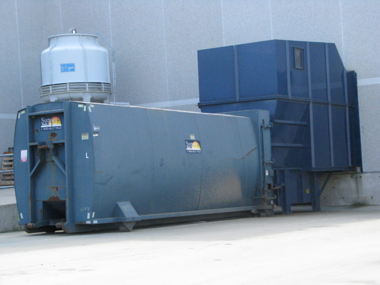 how does a trash compactor work